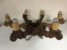 A carved oak six-branch chandelier