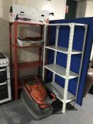 Two sets of metal shelving together with a Flymo lawn mower with lead and a boxed two-in-one mini