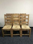 A set of six pine rush seated ladder back chairs