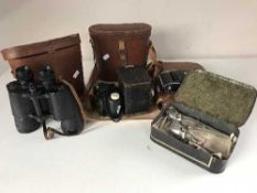 Two sets of binoculars in leather cases, leather cased gents travel set,
