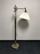 A heavy brass rise and fall standard lamp with shade