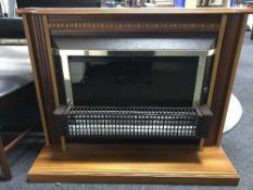 An electric fire in mahogany surround