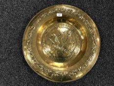 A early 20th century brass embossed charger