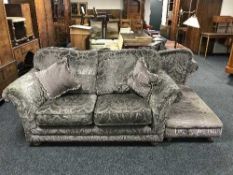 A contemporary three-seater settee and two seater settee in a floral print with scatter cushions