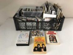 A crate of assorted newspapers, books, CDs,