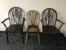 A set of six oak wheelback chairs comprising of two carvers and four singles