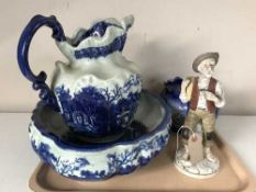 An Ironstone blue and white jug and basin, continental figurine,