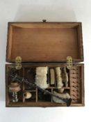 A gun cleaning kit in a fitted pine box