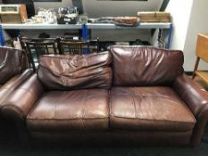 A contemporary brown leather two seater settee and armchair