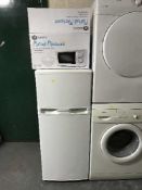 A fridge freezer and a boxed microwave