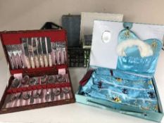 A basket of cased sets of cutlery, Scandinavian table lighter and ash tray,