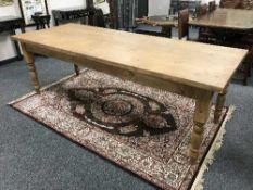 A pine farmhouse dining room table, length 244 cm.