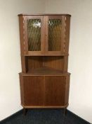 A mid-20th century teak corner cabinet