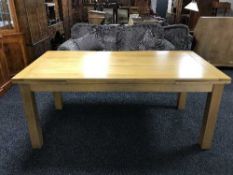 A contemporary oak pull-out dining table
