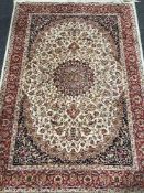 A fringed Persian Keshan rug on red ground 190 cm x 140 cm