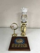 A brass ship's oil lamp with chimney and shade with gimble and Sun Insurance wall plaque