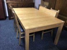 A contemporary oak extending table with two leaves and four chairs