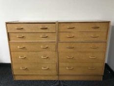 A pair of G-Plan oak five-drawer chests with matching dressing chest