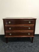 A mahogany three-drawer chest with brass drop handles