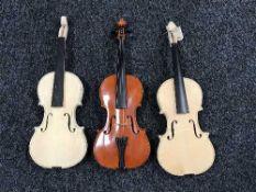 A violin and two un-finished violins
