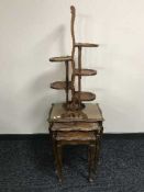 A oak five-way folding cake stand together with a nest of three walnut glass top tables