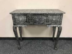 A silvered three drawer side table