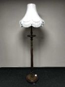 A heavily carved mahogany standard lamp and shade