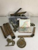 A quantity of horse brasses, vintage rulers, door knockers,