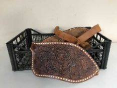 Assorted tooled leather horse tack and stirrups