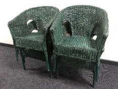 A set of four green wicker basket chairs