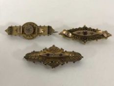 Three gold brooches, variously set with diamond and rubies, 10.