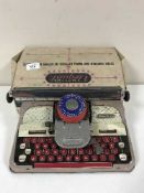 A boxed 1950's Mettoy Elequant tin plate typewriter