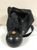 A bowls bag containing a set of imperial lawn bowls
