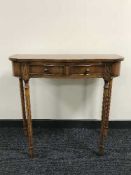 A mahogany hall table fitted with two drawers on reeded legs