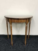 A d-shaped yew wood hall table and a Tiffany style banker's desk lamp