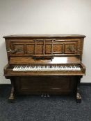 An oak cased overstrung piano by Townsend and Thompson of Edinburgh with brass candle sconces