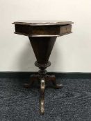 A Victorian walnut octagonal sewing table on three way support
