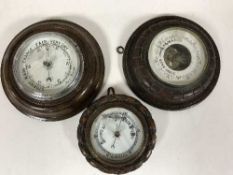 Three circular oak cased barometers