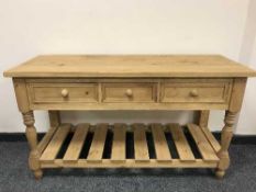 A reclaimed pine three drawer side table,