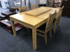 A contemporary oak extending table with two leaves and four chairs