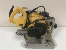A Dewalt 115 volt compound saw with transformer