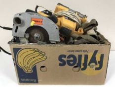 A box containing assorted power tools including hand saw, sander, woodworking planes, hard hats,