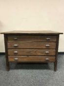An early twentieth century oak printer's chest of four drawers,