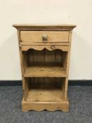 A reclaimed pine bedside cabinet fitted with a drawer,