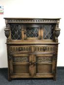 A carved oak leaded door buffet back sideboard