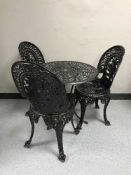 A circular cast metal patio table,