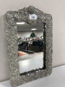 A ornate embossed dressing table mirror