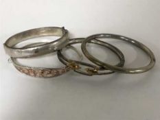 Four silver bangles