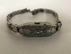 A lady's platinum and diamond set Longines cocktail watch, set with round, tapered,