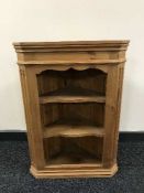 A pine wall mounted corner cabinet